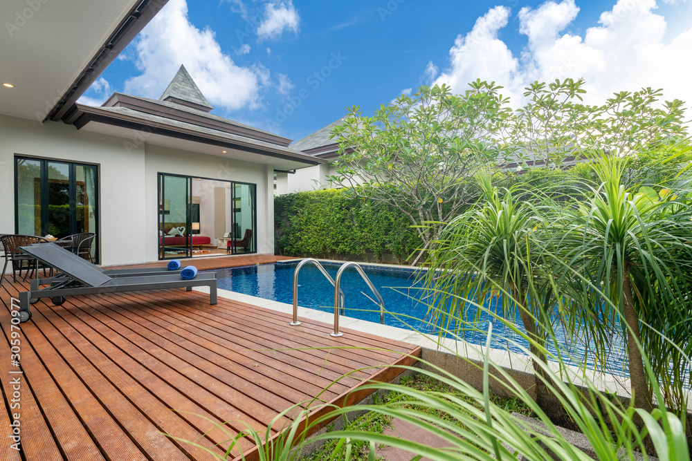 Modern home with a wooden deck, a private pool